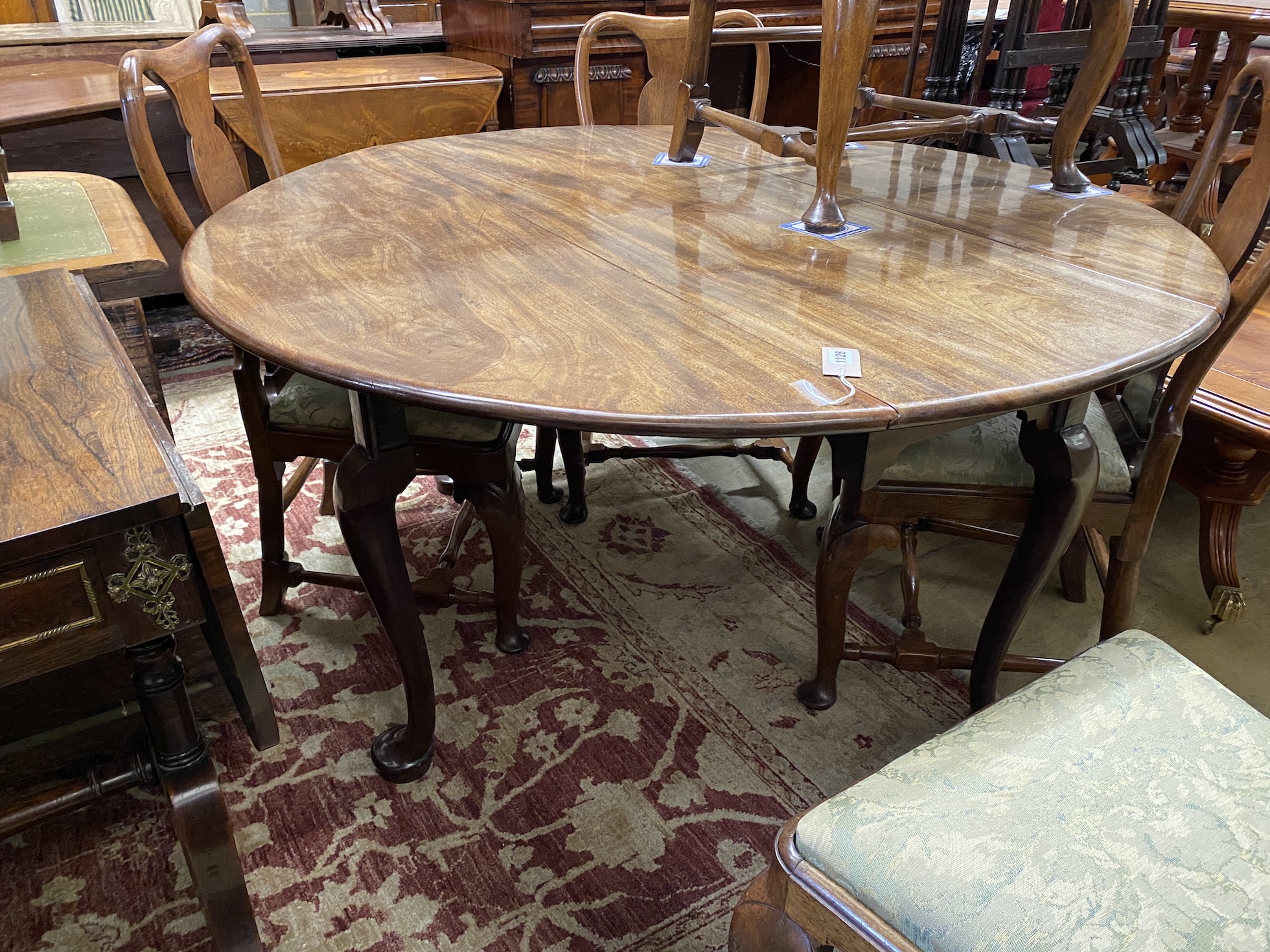 An 18th century circular mahogany drop leaf padfoot dining table, 140cm extended, height 70cm